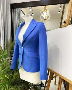 A Skye blue “Lady From Portland” Peak lapel business suit