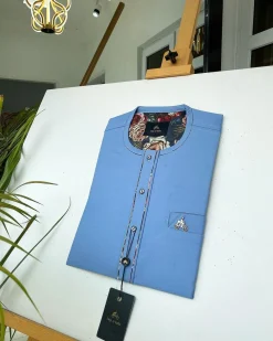 A Skye blue with paisley detailing, front flap with a matching Swarovski button detailing African kaftan and sokoto