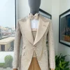 A splash of tortilla and wheat brown peak lapel metallic jacquard tuxedo suit