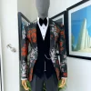 A “spring” orange, pink and green splashed floral layered front cut, shawl lapel tuxedo suit