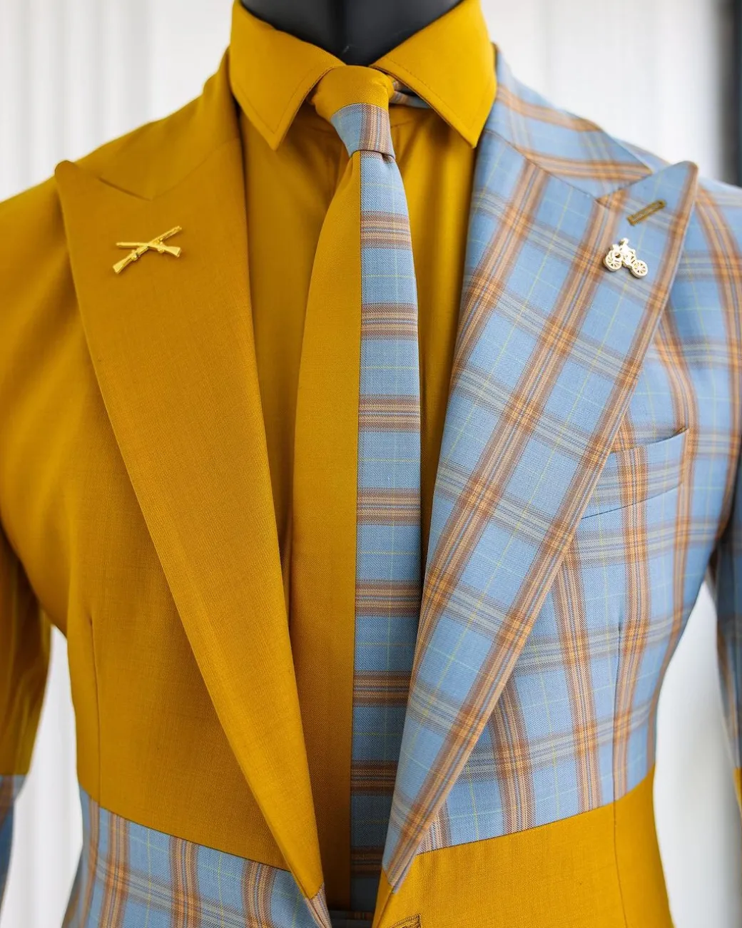 A “Square Shattered” yellow and broken tartan check in sapphire blue mix peak lapel suit