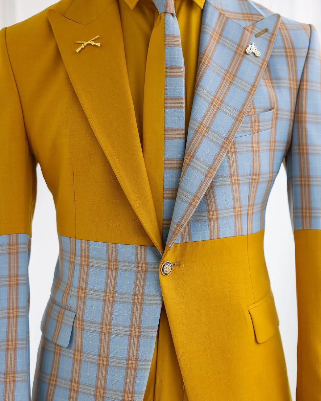 A “Square Shattered” yellow and broken tartan check in sapphire blue mix peak lapel suit