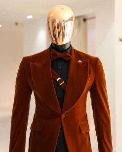 A Syrup Brown, Peak Lapel Tuxedo Suit With An Inner Slant Anchor.