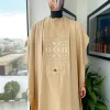 A Tan Brown, connected iron drop embroidery design with matching Agbada