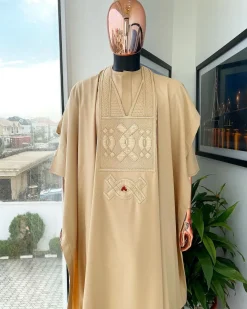 A Tan Brown, connected iron drop embroidery design with matching Agbada