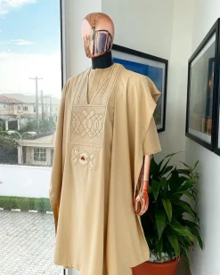 A Tan Brown, connected iron drop embroidery design with matching Agbada