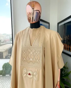 A Tan Brown, connected iron drop embroidery design with matching Agbada