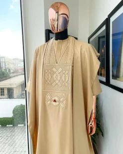 A Tan Brown, connected iron drop embroidery design with matching Agbada