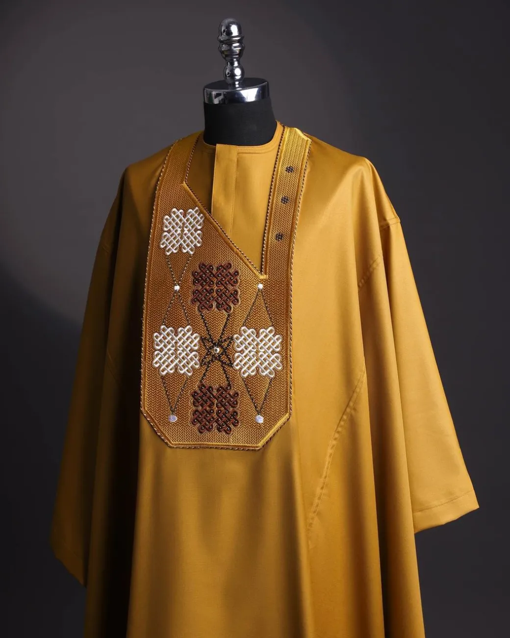 A tawny brown, “connected arewa ” embroidery details with laced Swarovski stone agbada