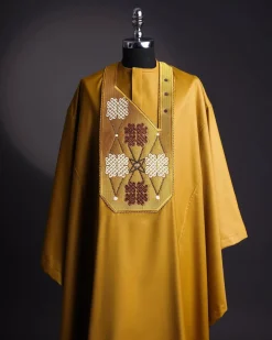 A tawny brown, “connected arewa ” embroidery details with laced Swarovski stone agbada