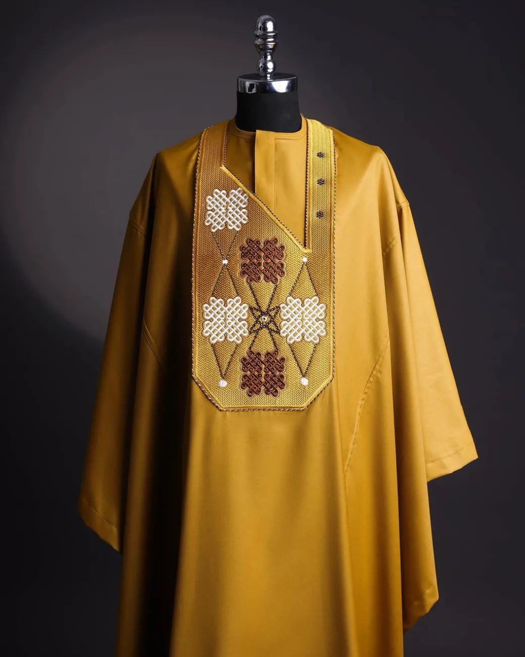 A tawny brown, “connected arewa ” embroidery details with laced Swarovski stone agbada