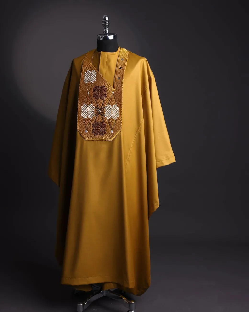 A tawny brown, “connected arewa ” embroidery details with laced Swarovski stone agbada