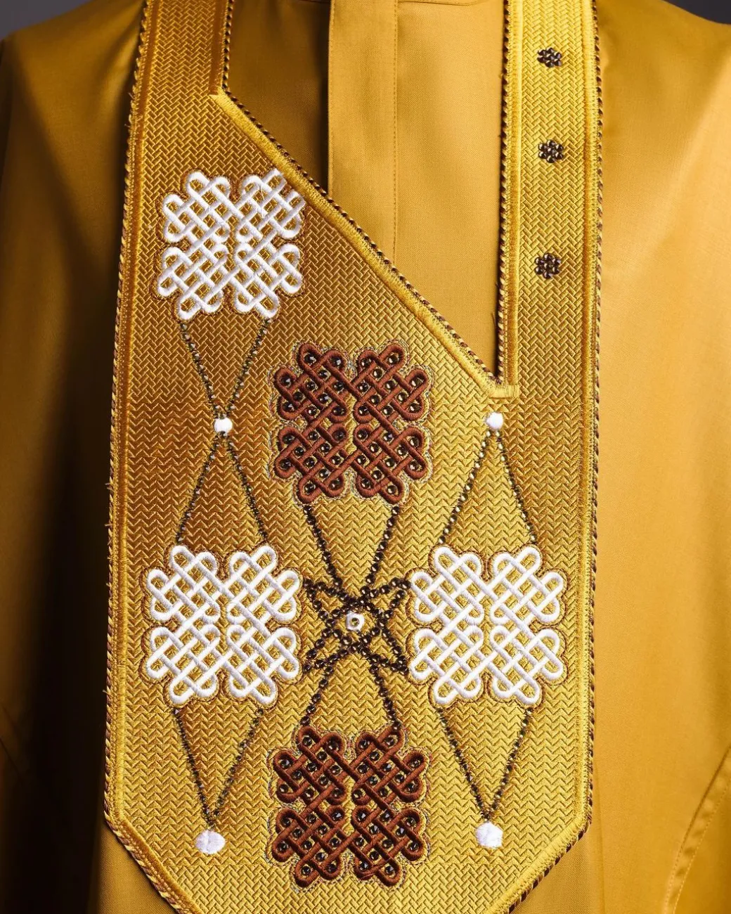 A tawny brown, “connected arewa ” embroidery details with laced Swarovski stone agbada