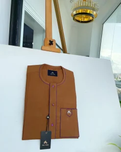 A Tawny brown, front flap, patch pocket, matching Swarovski buttons, paisley detailing African senator kaftan native.