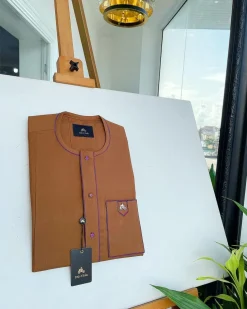 A Tawny brown, front flap, patch pocket, matching Swarovski buttons, paisley detailing African senator kaftan native.