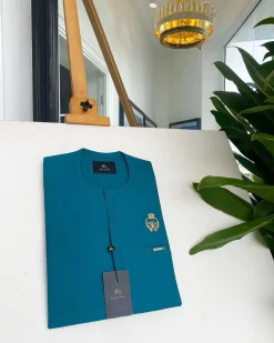 A teal green, tiny flap, and gold bee crown detail an African traditional senator kaftan native.