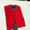 A tomato red flat design senator Kaftan with black Swarovski button African Kaftan