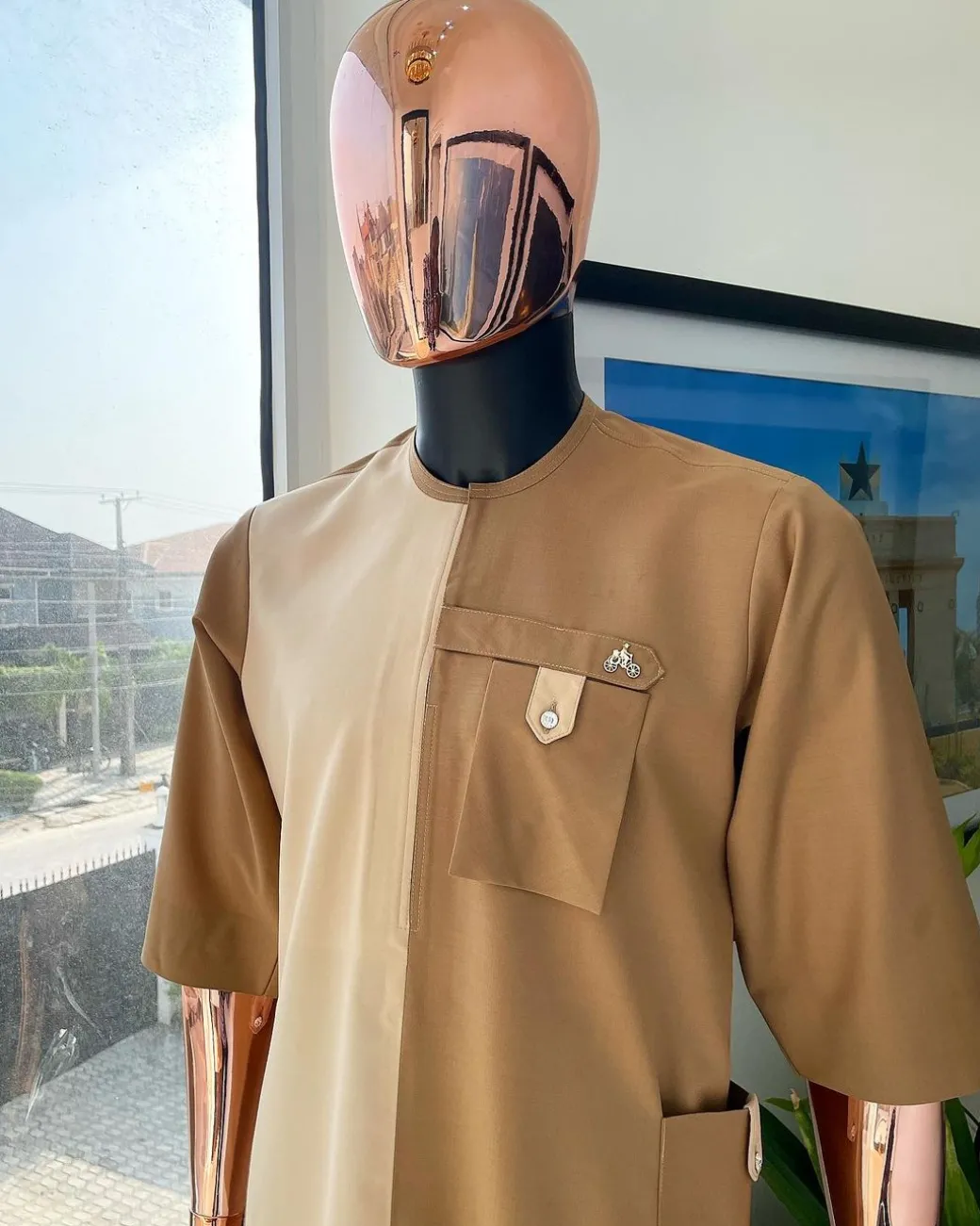 A Tortilla and peanut brown combat front and side pocket with a clear view of Swarovski stone detailing African traditional senator Kaftan native.