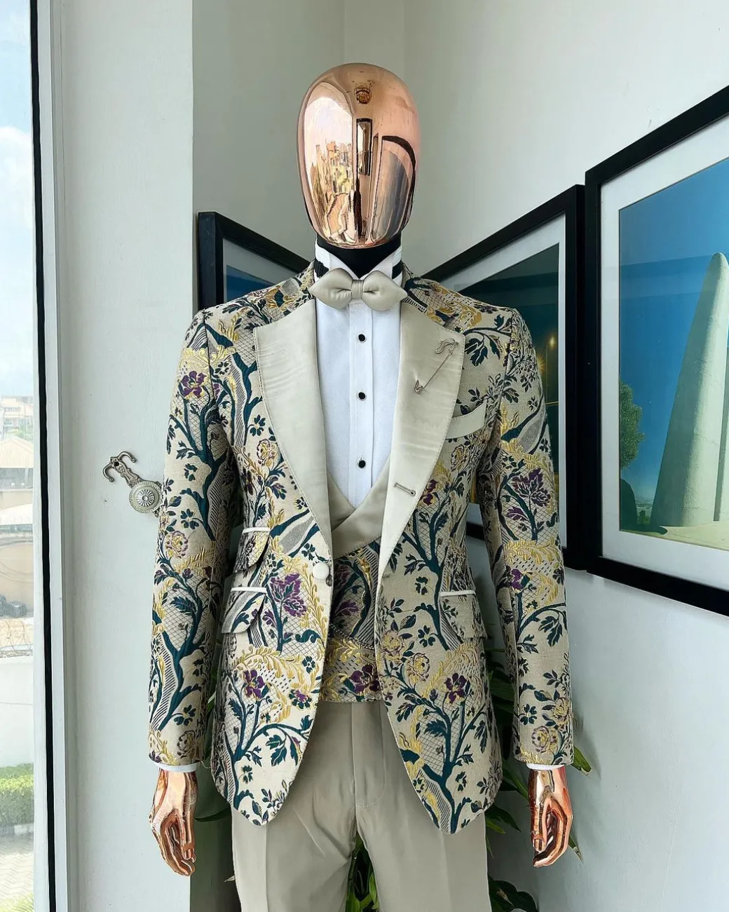 A Tortilla brown, emerald green, gold and splash of burgundy metallic floral jacquard peak lapel tuxedo suit
