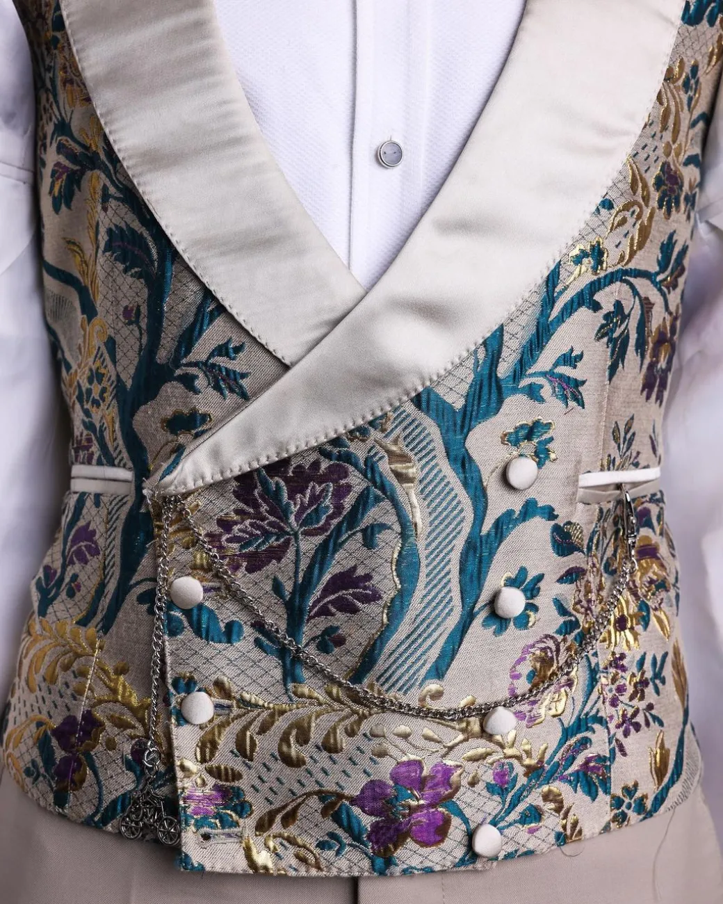 A Tortilla brown, emerald green, gold and splash of burgundy metallic floral jacquard peak lapel tuxedo suit