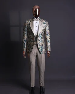 A Tortilla brown, emerald green, gold and splash of burgundy metallic floral jacquard peak lapel tuxedo suit