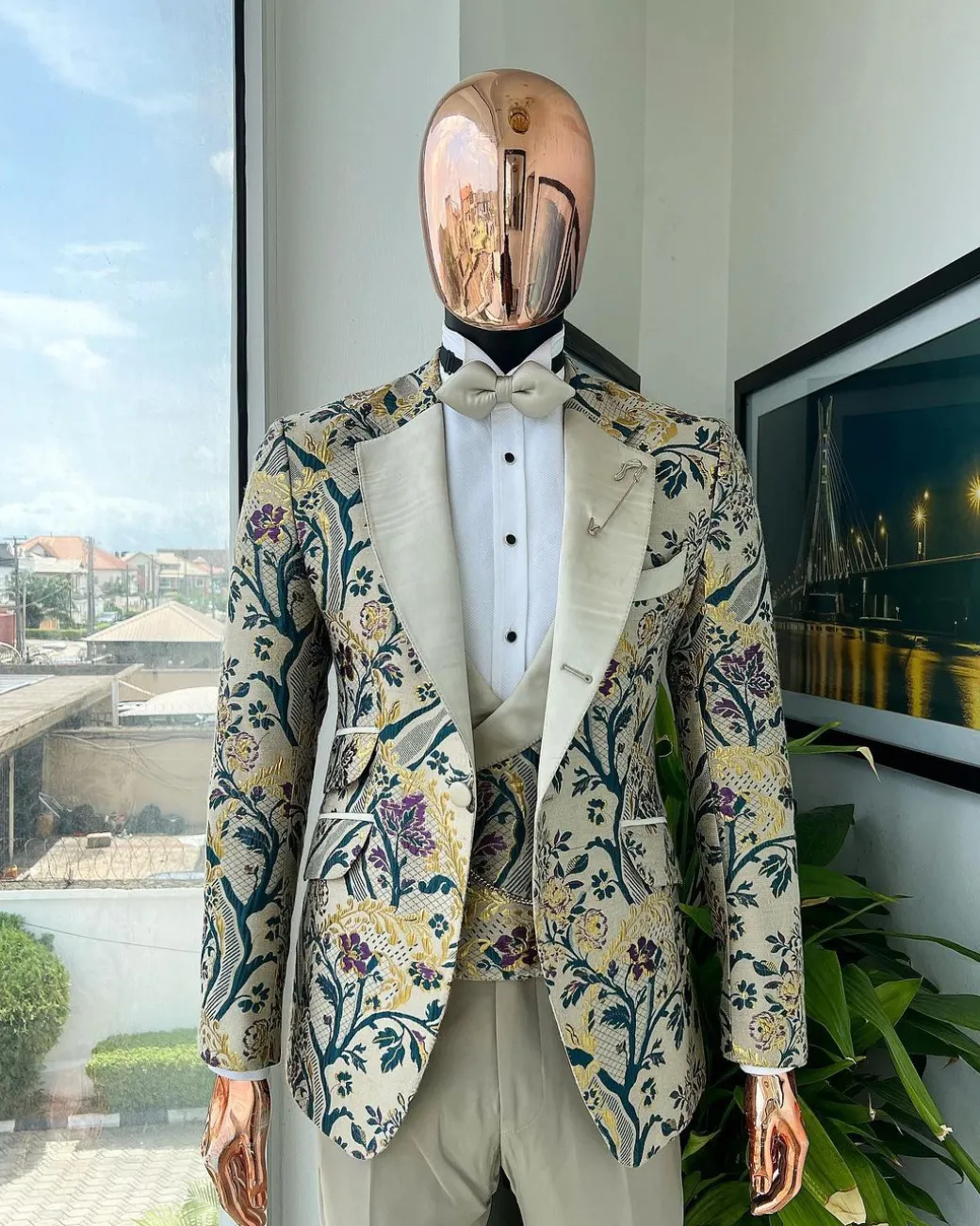 A Tortilla brown, emerald green, gold and splash of burgundy metallic floral jacquard peak lapel tuxedo suit