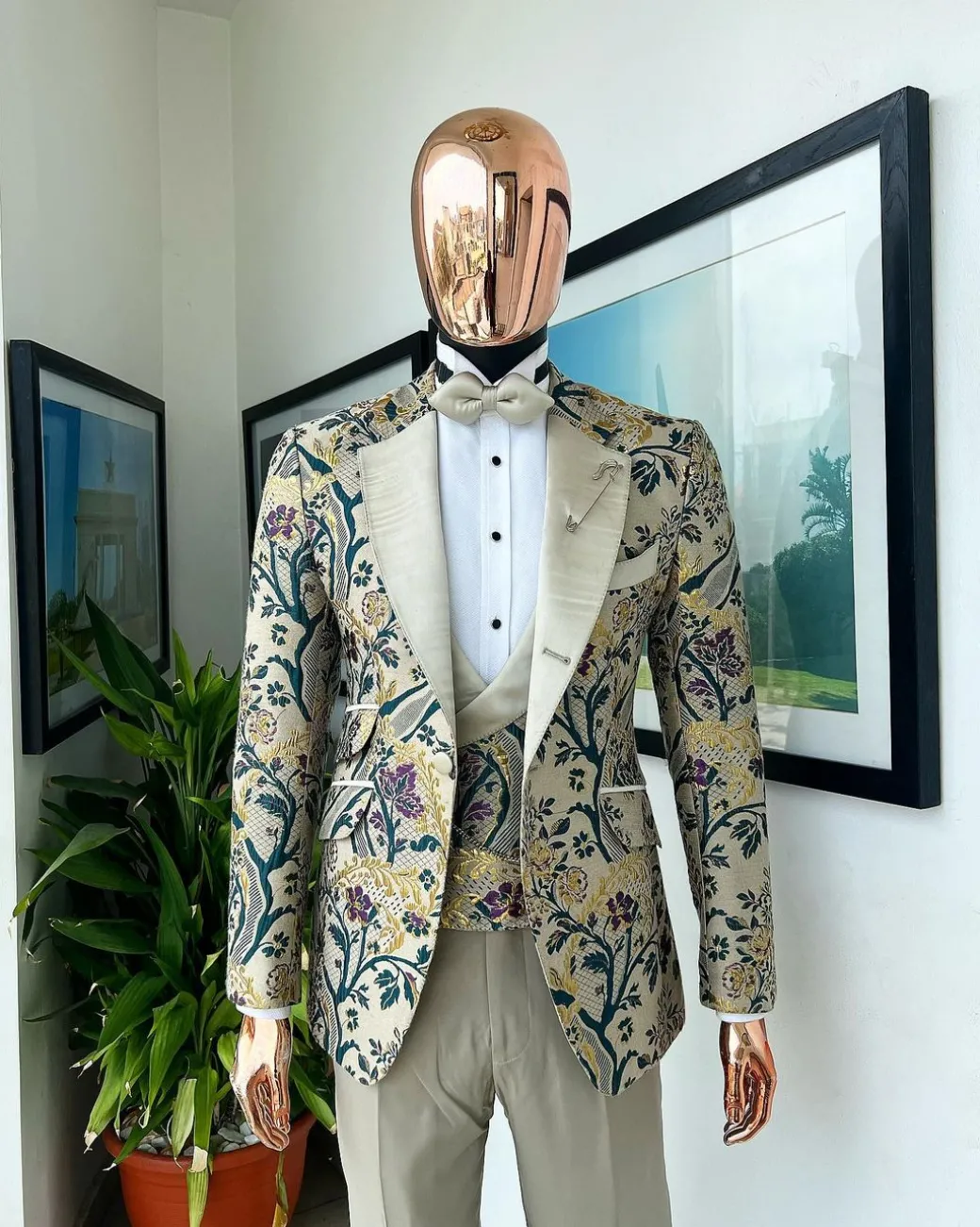 A Tortilla brown, emerald green, gold and splash of burgundy metallic floral jacquard peak lapel tuxedo suit