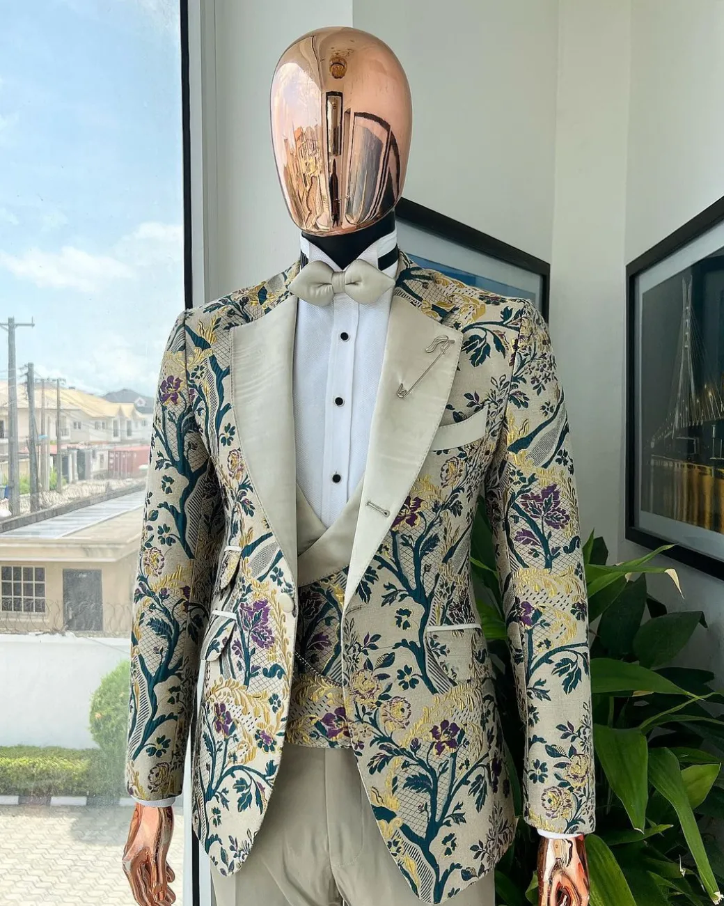 A Tortilla brown, emerald green, gold and splash of burgundy metallic floral jacquard peak lapel tuxedo suit