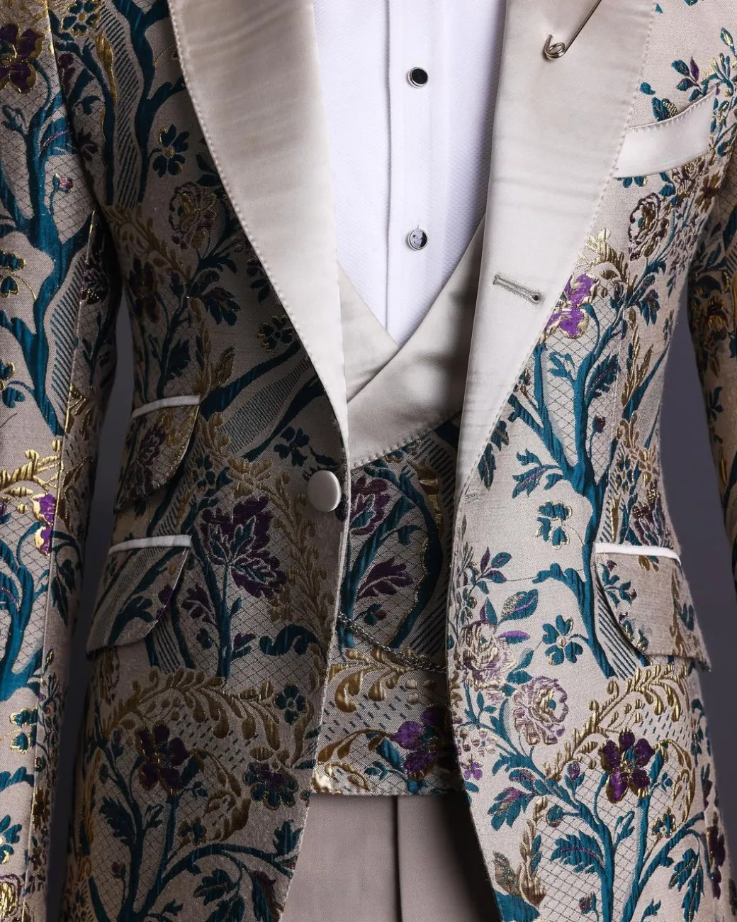 A Tortilla brown, emerald green, gold and splash of burgundy metallic floral jacquard peak lapel tuxedo suit