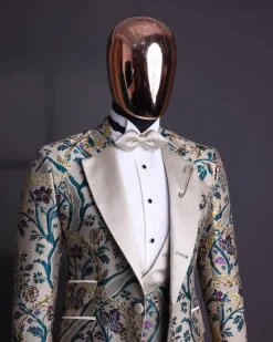 A Tortilla brown, emerald green, gold and splash of burgundy metallic floral jacquard peak lapel tuxedo suit