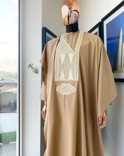A Tortilla Brown, interconnected embroidery details agbada, buba and sokoto