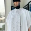 A white, connected square embroidery design with matching silver and black Swarovski stone details agbada