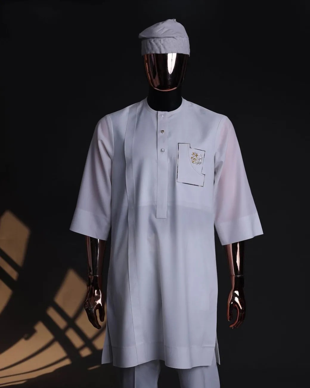 A White, curved and square shaped pocket with floral embrodery details, 3/4 sleeve African senator kaftan native.