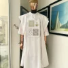 A white, dripping stars and interconnected maze embroidery details agbada