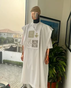 A white, dripping stars and interconnected maze embroidery details agbada