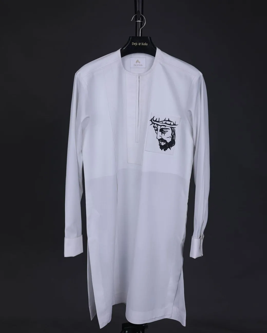 A white, front flap, Zip line with crown to Golgotha embrodery details African senator kaftan native.