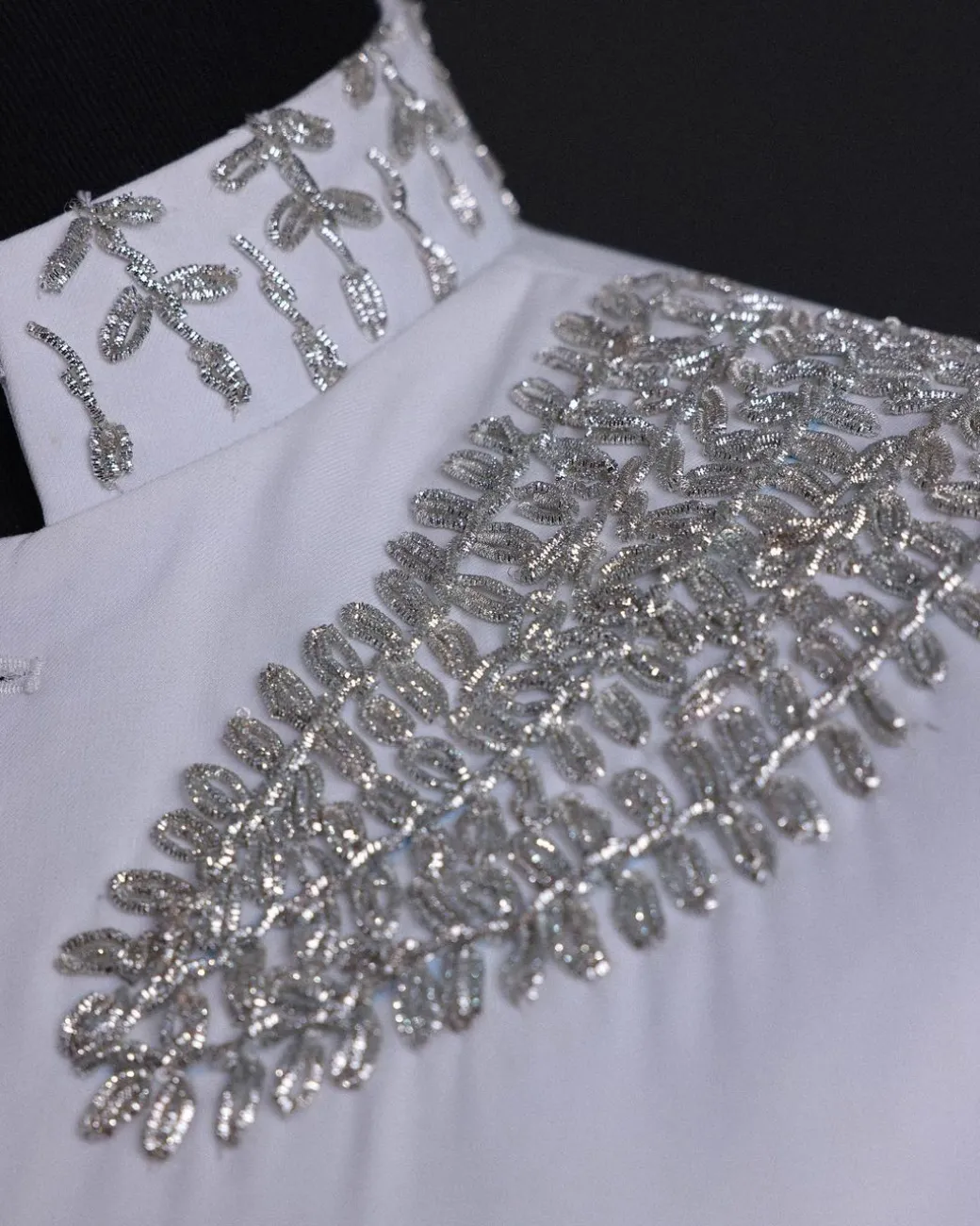 A white, hand “ide” silver metal wire embroidery, right hand sache safari suit