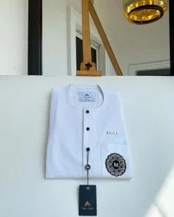 A white mix kaftan, button front flap, hand embroidery patch and black Swarovski detailing African Kaftan and Sokoto