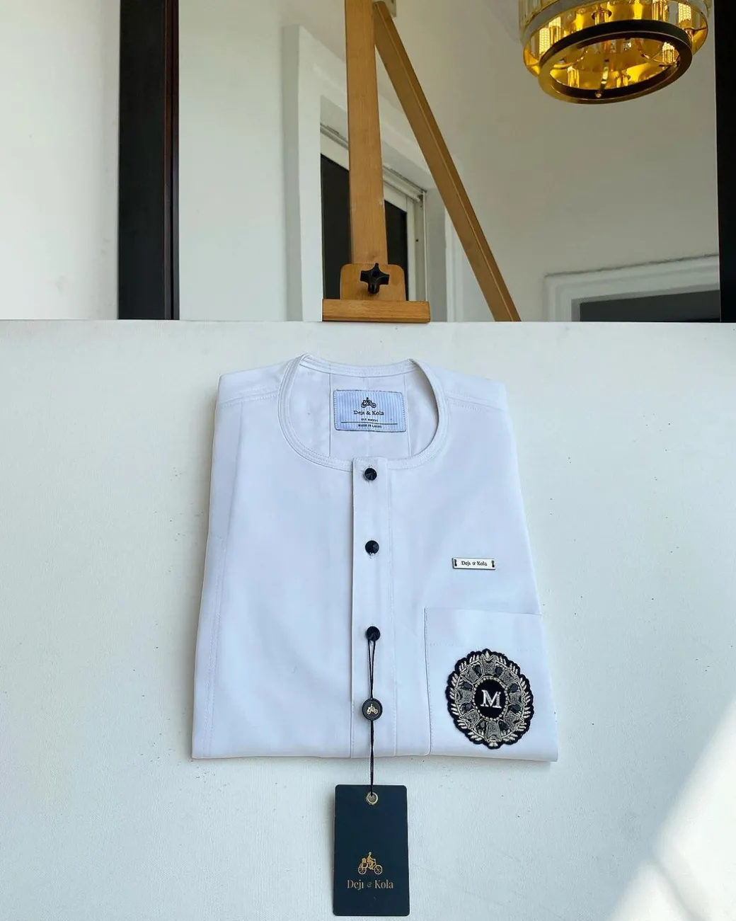 A white mix kaftan, button front flap, hand embroidery patch and black Swarovski detailing African Kaftan and Sokoto
