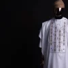 A white, shattered interwoven embroidery with Swarovski stones details agbada
