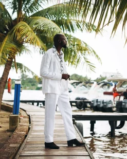 A White “Tropicana” Linen Overcoat & Wide Cut Pant Trousers.