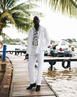 A White “Tropicana” Linen Overcoat & Wide Cut Pant Trousers.