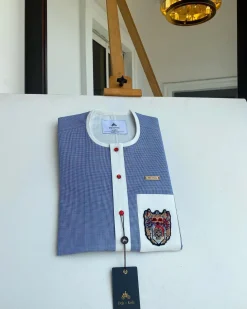 A Windowpane check blue and white mix front flap, hand embroidery patch detailing, and a red Swarovski African Kaftan and Sokoto
