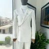 A wrap and strapped ivory white, peak lapel suit