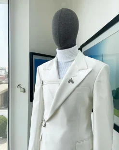 A wrap and strapped ivory white, peak lapel suit