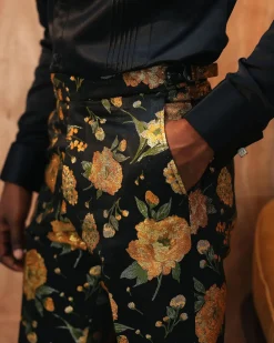 A yellow, silk black jacquard pants with a splash of gold print.
