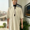 An Almond cream, lane, intersection flap, side patch pocket detailing african traditional senator kaftan native.