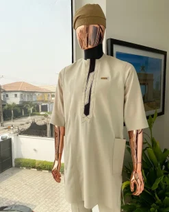 An Almond cream, lane, intersection flap, side patch pocket detailing african traditional senator kaftan native.