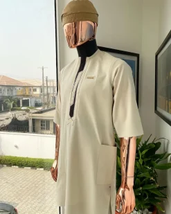 An Almond cream, lane, intersection flap, side patch pocket detailing african traditional senator kaftan native.
