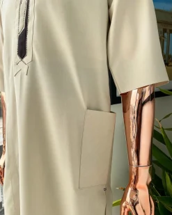 An Almond cream, lane, intersection flap, side patch pocket detailing african traditional senator kaftan native.